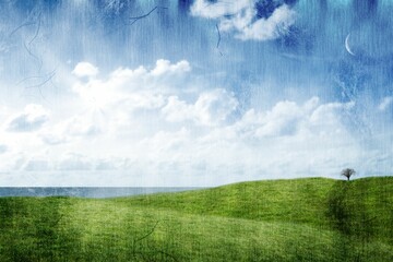 Green hill against cloudy sky