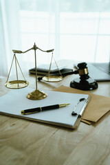 An Asian man in a suit is signing an important document indoors, which symbolizes power, finance,...