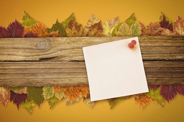 Autumn leaves with yellow note