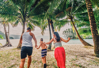 family running on the beach on Ko Kood island	

