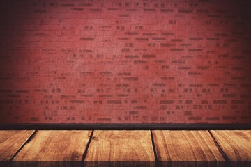 Light falling on red brick wall against floorboard