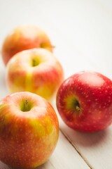 Fresh red apples on table