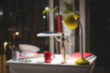 Wooden figurine by illuminated lamp