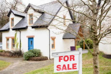 For sale signboard outside house