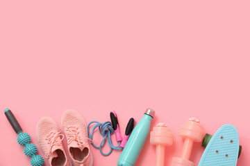 Set of sports equipment and shoes on pink background