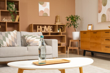 Bottle of water on table in living room
