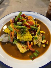 Papaya Salad contained with Corn, Fresh Shrimp, chopped tomatoes and vegetables. It’s a spicy...