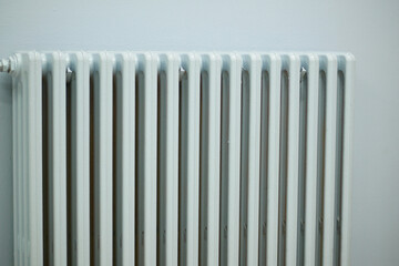 White radiator against a plain wall in a modern space