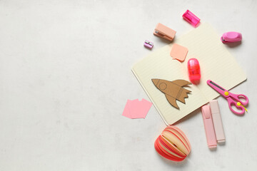 Paper rocket with markers and different stationery on white background. Top view