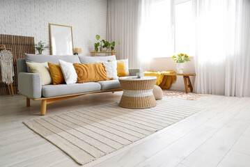 Interior of modern light living room with sofa and table