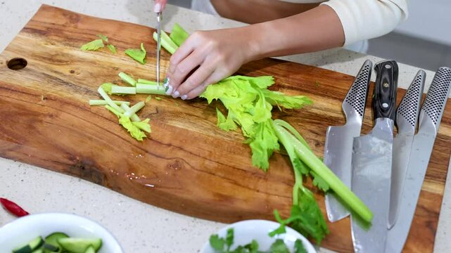 Chopping Celery on Wooden Cutting Board