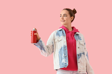 Fototapeta premium Young woman with spray paint can on pink background
