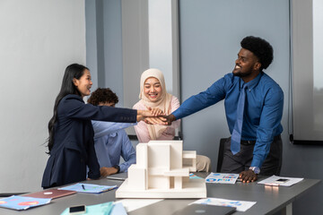 Diverse business team joining hands in unity, asian, african and muslim coworkers show teamwork and...