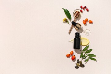 Beautiful composition with bottle of essential oil and natural ingredients on color background