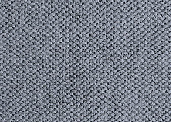 Gray linen carpet sewn using machine power.