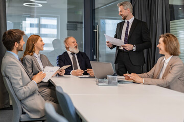 Professional executive businesspeople discuss corporation project planning sit at meeting room,...
