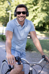 man enjoying music using earphones while commuting on a bicycle
