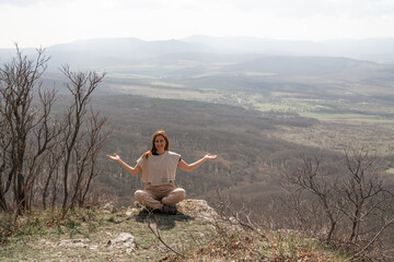 Meditation Woman Nature: Woman meditates outdoors in mountains during daytime for relaxation