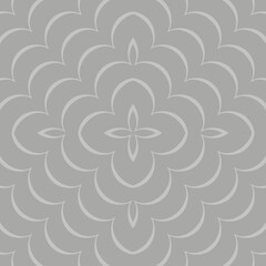 A symmetrical floral pattern with an intricate design, featuring repeating petal shapes and a central flower-like motif in a monochromatic gray tone. 