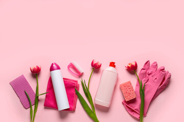 Cleaning supplies with spring flowers on pink background