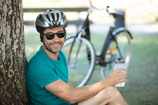cyclist man on the grass meditating