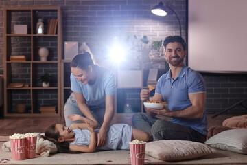 Family having fun during watching of movie at home