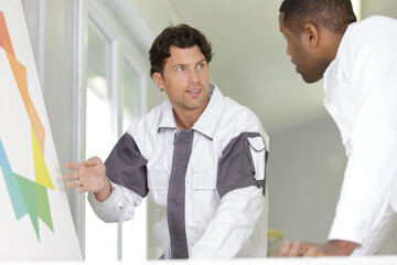 renovation painter talking while doing the project