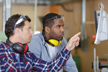 two carpenters work hard in the workshop