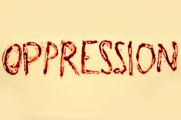 Word OPPRESSION written in blood on beige background