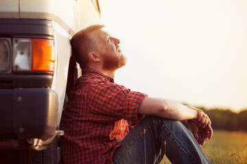 Truck driver takes a break from work.