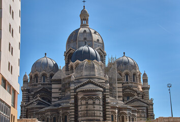 Domes and towers of the Marseille Cathedral of Sainte-Marie-Majeure in the La Joliette district, neo-Byzantine architecture under a blue sky