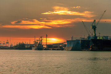 Industry landscape on sunset Engineering shipping crane depot at logistic export terminal control....