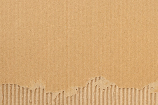 Brown cardboard sheet abstract background, texture of recycle paper box in old vintage pattern with ripped edges.