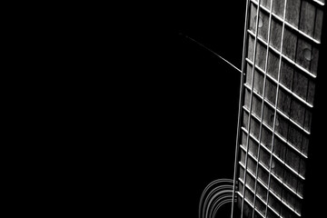 black acoustic guitar on a black background, silhouette. black and white, close-up