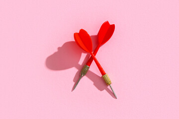 Red darts on pink background