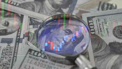 red down arrow inside a magnifier overlays a U.S. dollar banknote, representing economic recession, market decline, and financial challenges in the United States economy. stock market loss.