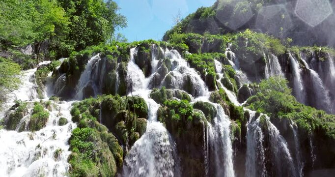 Waterfalls And Mossy Cliffs At Plitvice Lakes National Park In Croatia. - aerial ascend shot