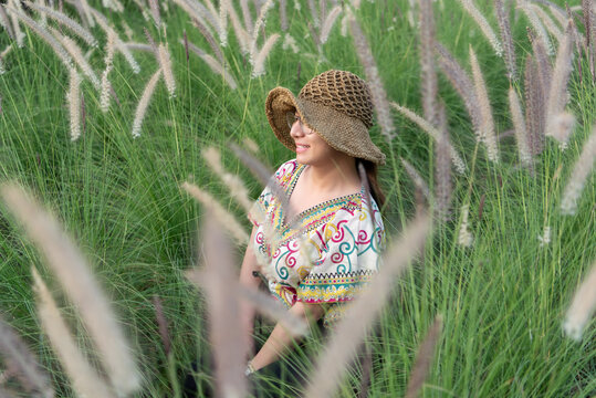 Beautiful asian woman (LGBTQ) natural makeup wear fashion relax clothes posing at nature of flower park or flower garden field lush growing for travel popular landmark in asia outdoor fashion style - Powered by Adobe