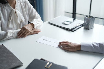 Business man sending resignation letter to boss and Holding Stuff Resign Depress or carrying cardboard box by desk in office