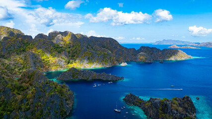 Aerial view of a beautiful tropical island with crystal clear water  with limestone cliffs  as the beach, Coron, Palawan, Philippines.