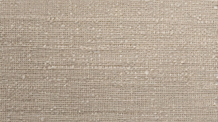 Close up texture of a beige woven fabric with raised bumps and subtle water droplets