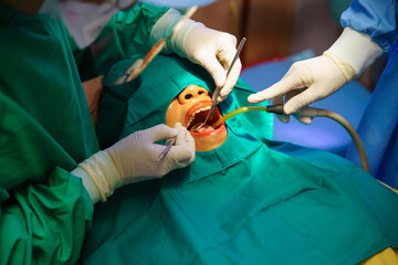 Dentist at work or Concentrated specialist removing tooth stone from client's teeth using...
