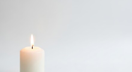 White Candle Burning with Flame on Minimalist White Background for Calm and Relaxation