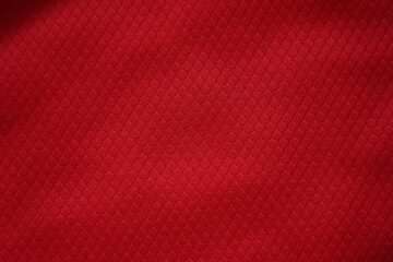Close up of red football jersey sports clothing fabric texture.
