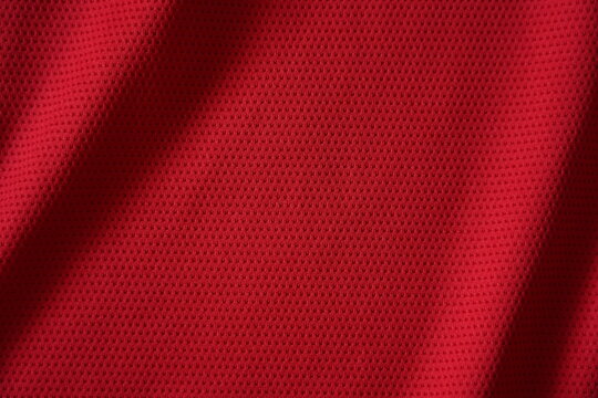 Close up of red football jersey sports clothing fabric texture.