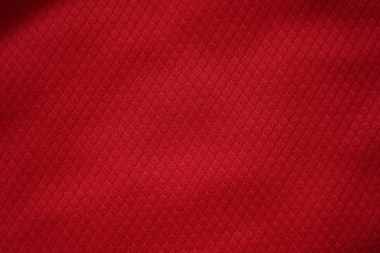 Close up of red football jersey sports clothing fabric texture.