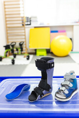Various rehabilitation shoes, foot orthosis and insoles for children are showcased in room designed...