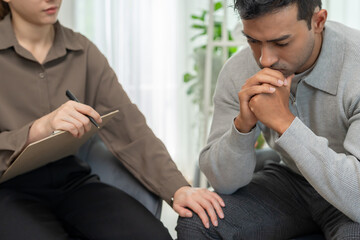 psychiatrist touch feel worried while discussing life and family issues. doctor encourages and...