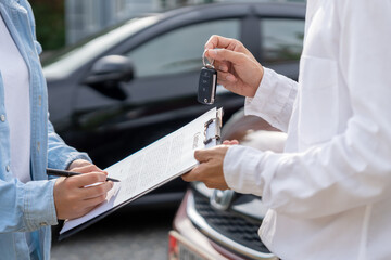 lease, rental car, sell, buy. Dealership manager send car keys to the new owner.  Sales, loan...