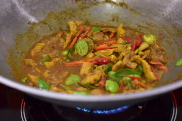 Spicy stir fried pork with Cluster Bean (Bitter Bean or stink beans) popular southern Thai food, Spicy stir fried chicken with Cluster Bean (Bitter Bean or stink beans).Thai southern food